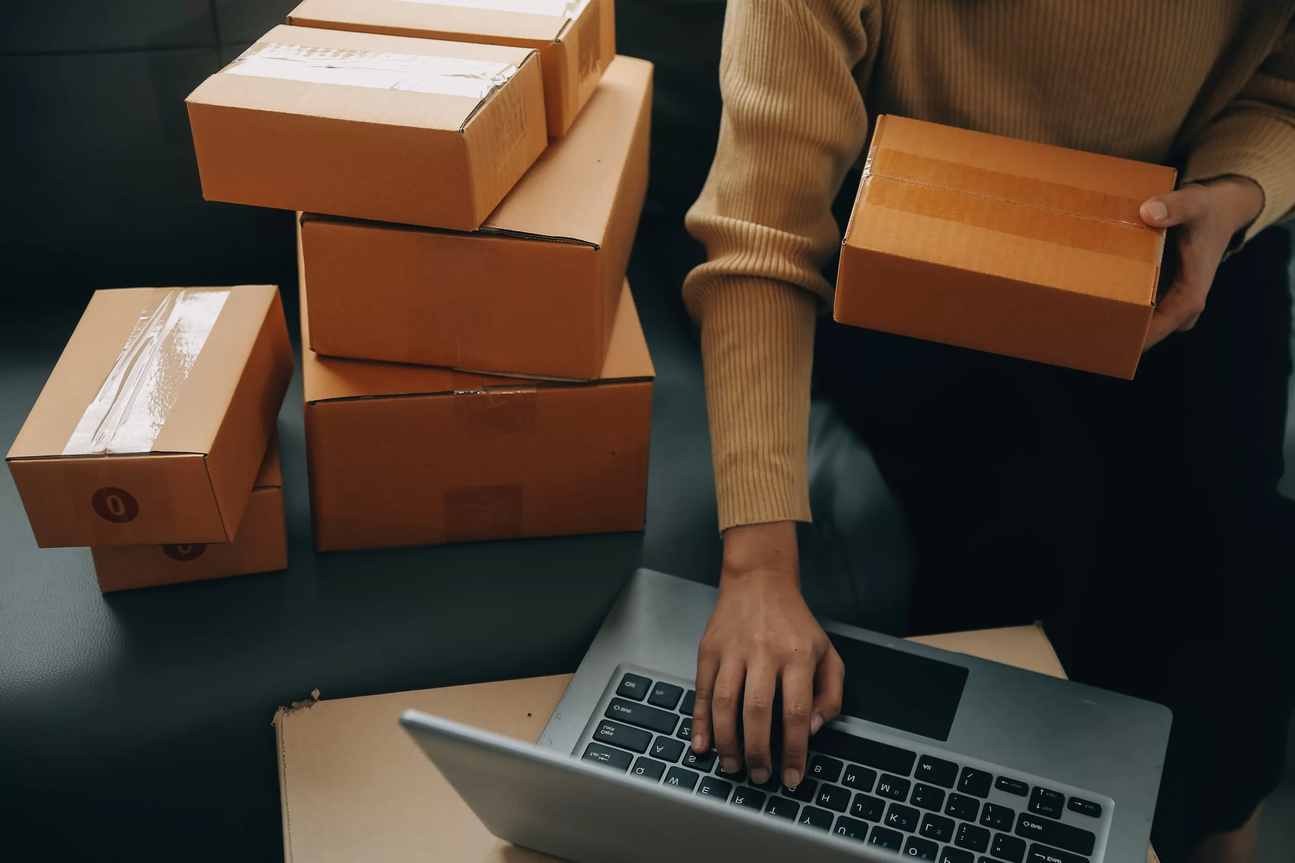 business woman with laptop and boxes